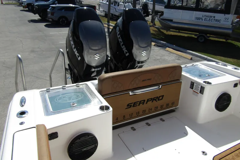 Slide: The Image of 2025 Sea Pro 322 Offshore boat with dual Suzuki 350 engines, docked in a marina. - 35