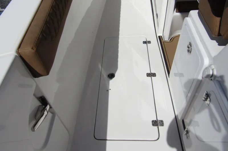 Slide: The Image of 2025 Sea Pro 322 Offshore boat deck with storage compartment and cushioned seating. - 44