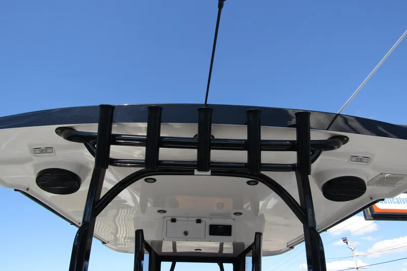 Slide: The Image of 2025 Sea Pro 322 Offshore boat roof with rod holders against clear blue sky. - 45