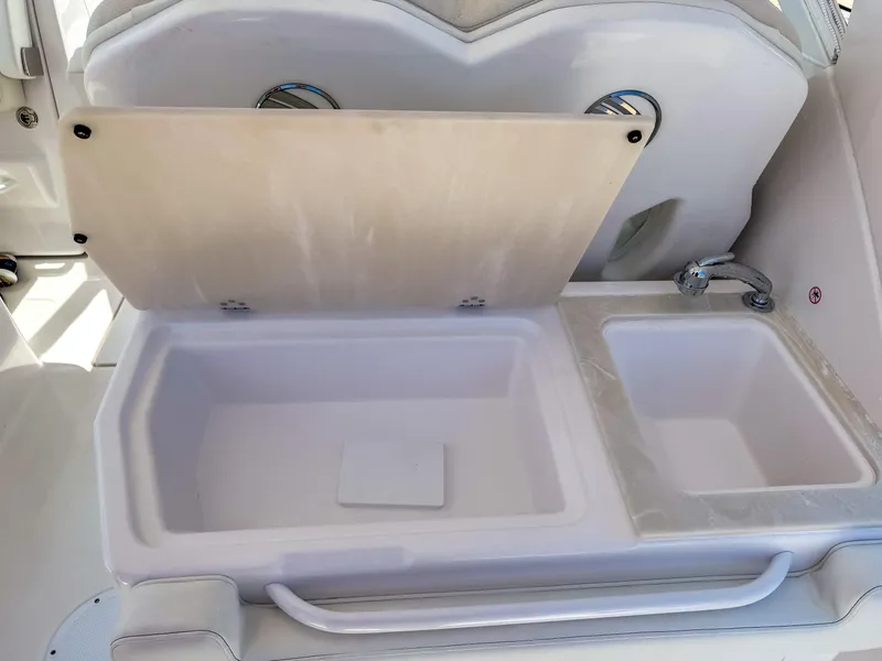Slide: The Image of 2025 Edgewater 262 CX boat interior with open storage compartments. - 26