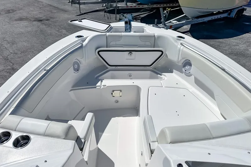 Slide: The Image of 2025 Edgewater 262CX Crossover boat interior with seating and storage compartments. - 42
