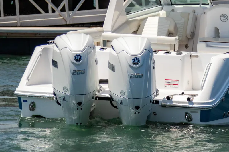 Slide: The Image of 2025 Edgewater 262 CX boat with dual Yamaha 200 outboard engines in water. - 6