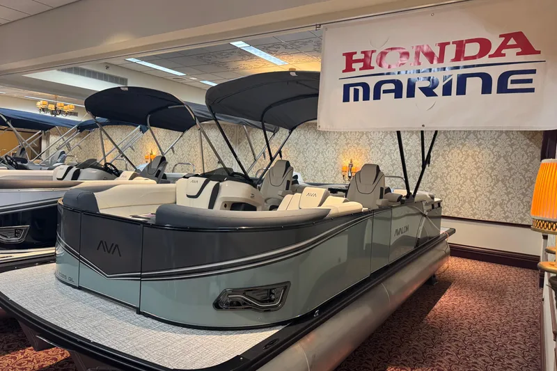 The Image of 2026 Avalon LSL QL pontoon boat displayed indoors under Honda Marine banner. - 4