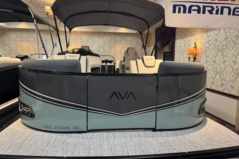 Slide: The Image of 2026 Avalon LSL QL pontoon boat displayed indoors with elegant seating and canopy. - 5