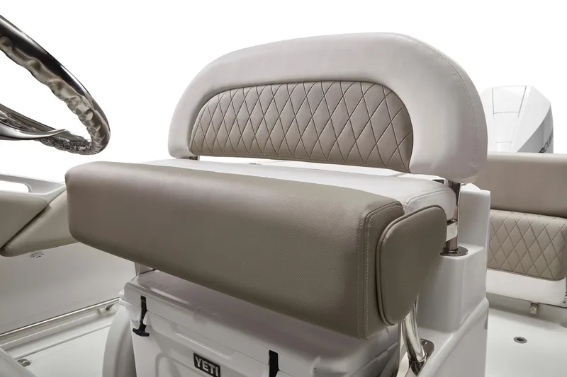 Slide: The Image of 2026 Finseeker 220 CC boat seat with diamond-stitched upholstery and steering wheel detail. - 4