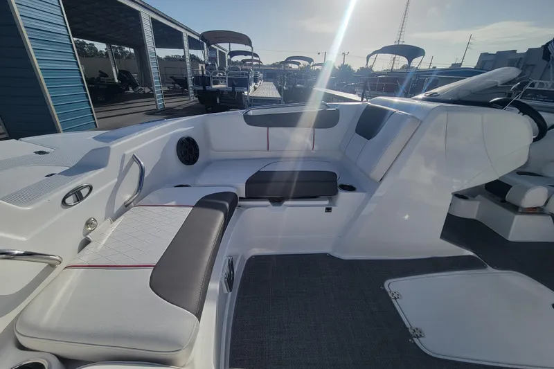 Slide: The Image of Interior of a 2023 Tahoe 1950 boat with cushioned seating and modern design. - 11
