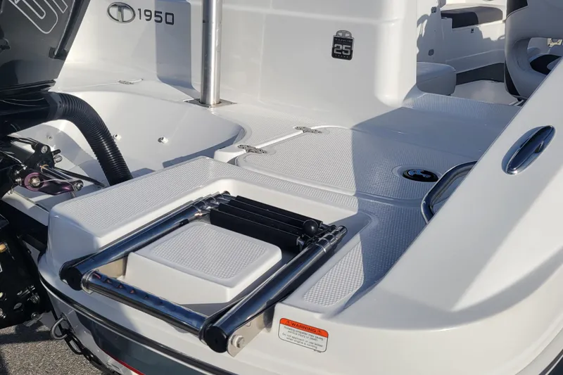 Slide: The Image of 2023 Tahoe 1950 boat deck with ladder and engine details. - 16