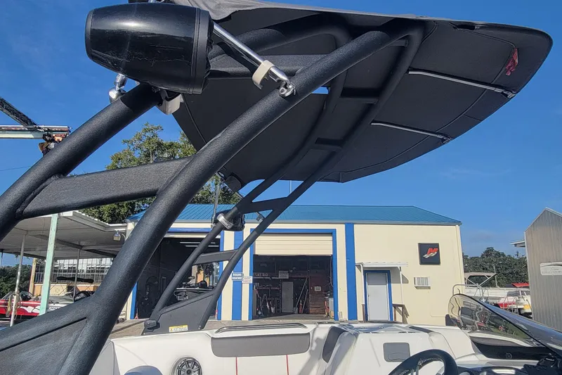 Slide: The Image of 2023 Tahoe 1950 boat with a sleek black canopy and modern design. - 19