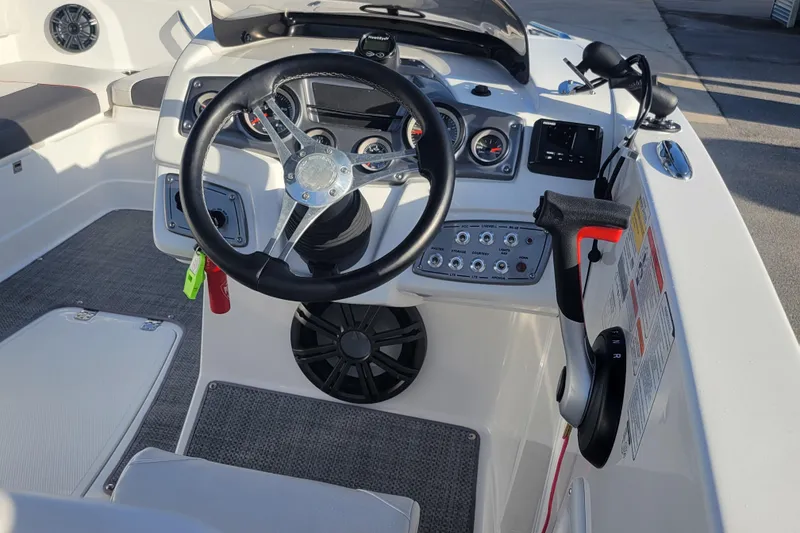 Slide: The Image of Steering console of a 2023 Tahoe 1950 boat with modern controls and gauges. - 20
