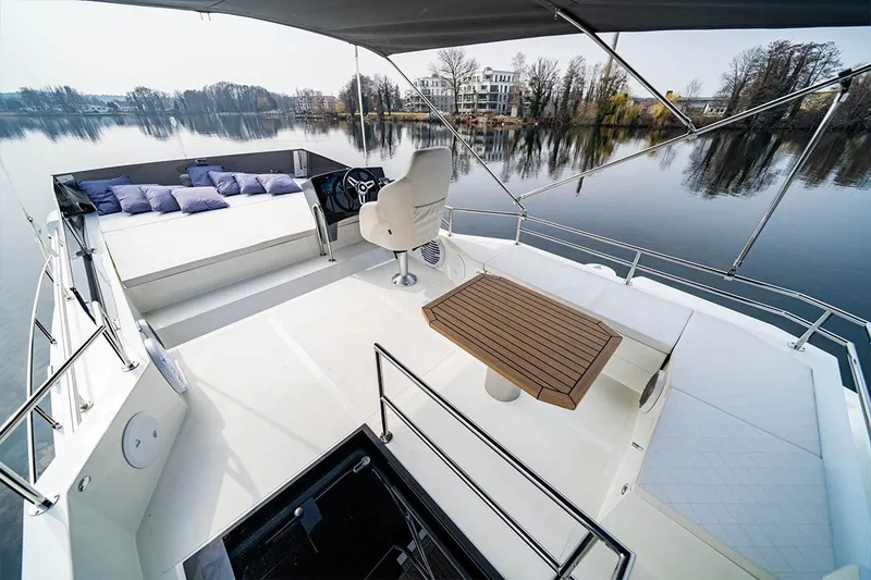 Slide: The Image of Luxurious 2025 Cobra Sea Master yacht with spacious deck and elegant seating on calm waters. - 7