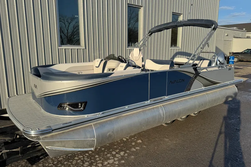 The Image of 2026 Avalon LSZ Entertainer pontoon boat with sleek design, docked outdoors. - 0