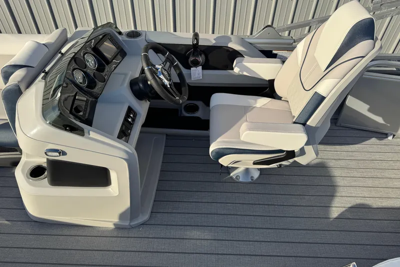 Slide: The Image of 2026 Avalon LSZ Entertainer boat helm with modern dashboard and comfortable captain's chair. - 10