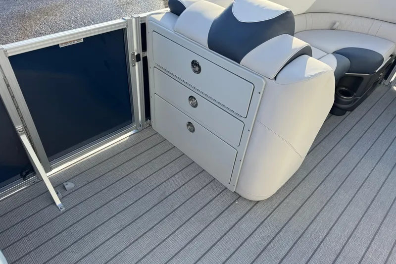 Slide: The Image of 2026 Avalon LSZ Entertainer boat interior with seating and storage compartments. - 19