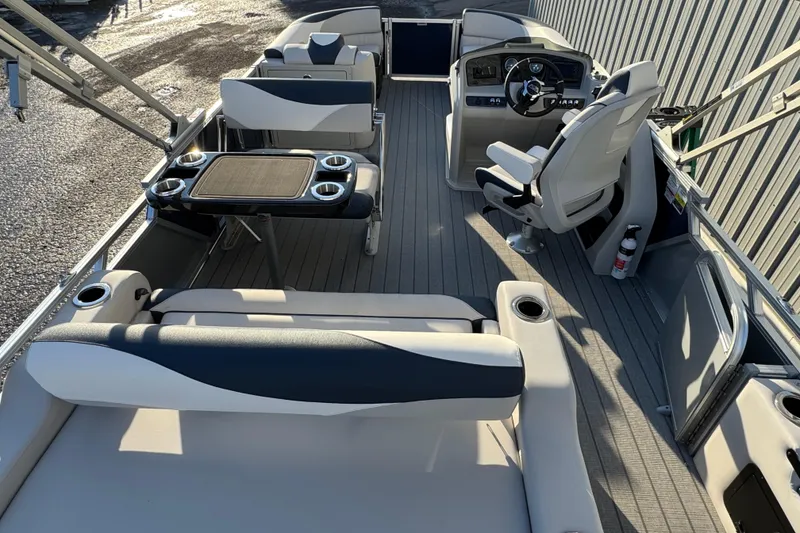 Slide: The Image of 2026 Avalon LSZ Entertainer pontoon boat interior with seating and steering console. - 6