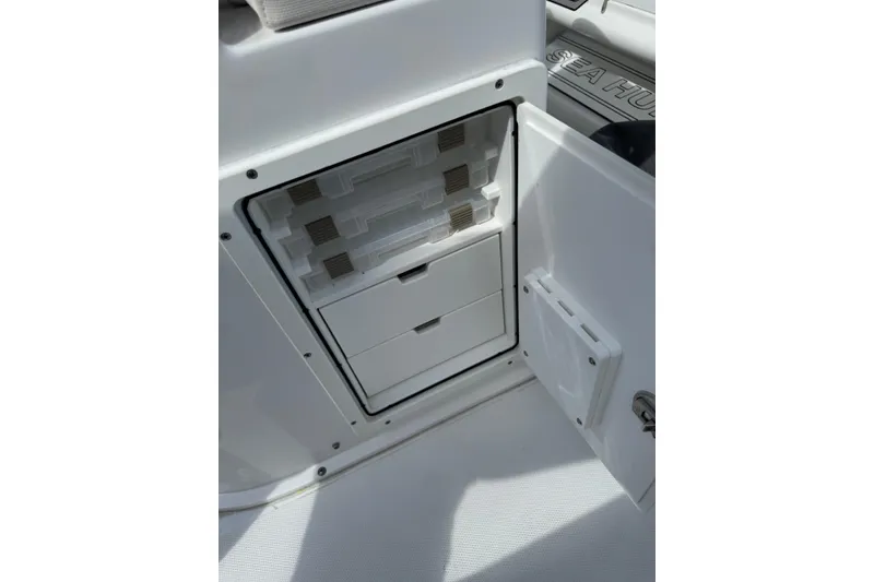 Slide: The Image of 2024 Sea Hunt Gamefish 27 storage compartment with tackle boxes and drawers. - 12