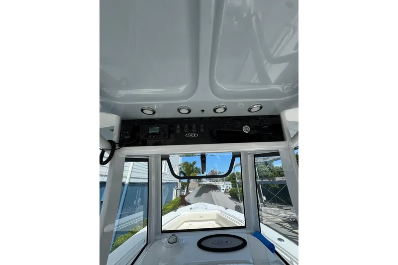 Slide: The Image of 2024 Sea Hunt Gamefish 27 Forward Seating boat interior with control panel and seating view. - 15