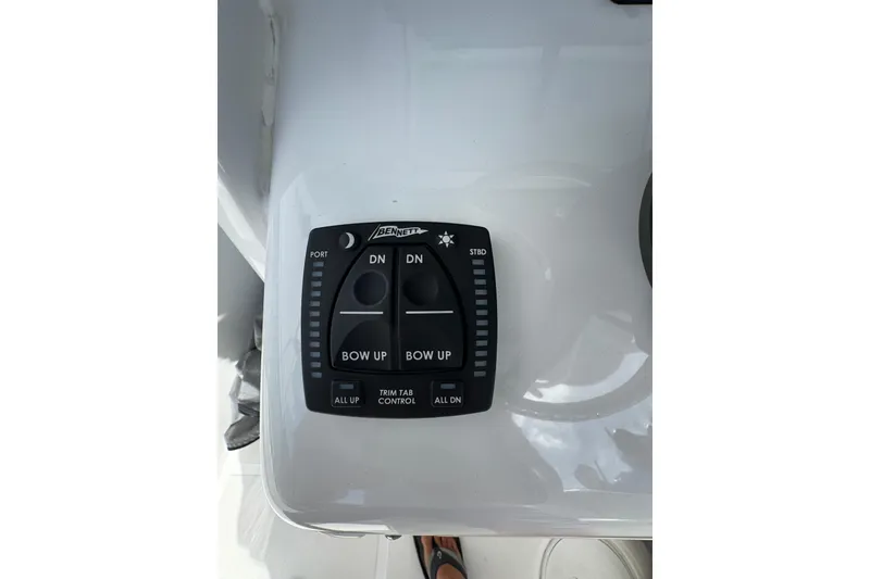 Slide: The Image of 2024 Sea Hunt Gamefish 27 trim tab control panel on boat dashboard. - 16