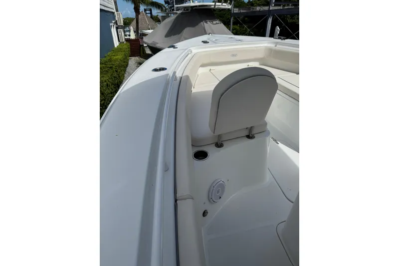 Slide: The Image of 2024 Sea Hunt Gamefish 27 Forward Seating boat interior with white seating and sleek design. - 18