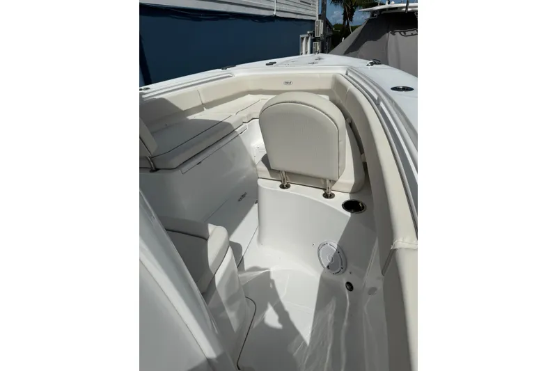 Slide: The Image of 2024 Sea Hunt Gamefish 27 Forward Seating interior with white cushioned seats. - 19