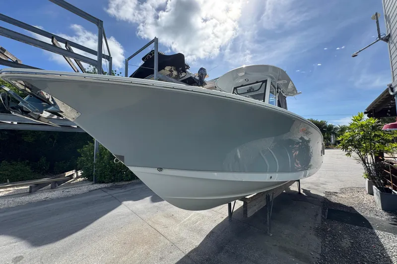 Slide: The Image of 2024 Sea Hunt Gamefish 27 Forward Seating boat on display under a clear sky. - 2