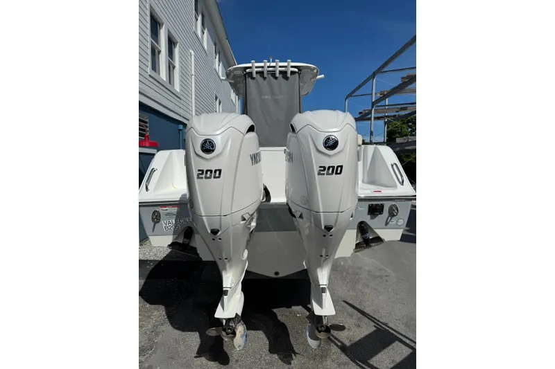 Slide: The Image of 2024 Sea Hunt Gamefish 27 with twin Yamaha 200 engines, docked outdoors. - 4