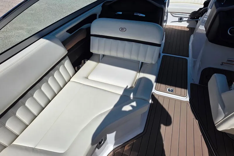 Slide: The Image of Interior of 2013 Cobalt A25 boat with white leather seating and brown flooring. - 12