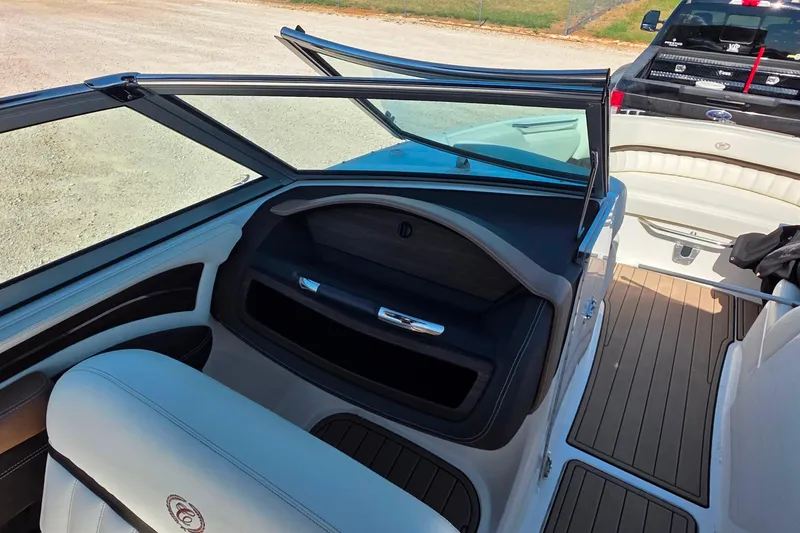 Slide: The Image of Interior of a 2013 Cobalt A25 boat with seating and dashboard details. - 13