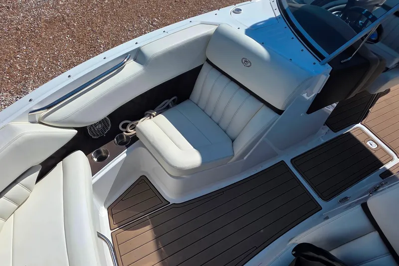 Slide: The Image of 2013 Cobalt A25 boat interior with white seating and wood-style flooring. - 19