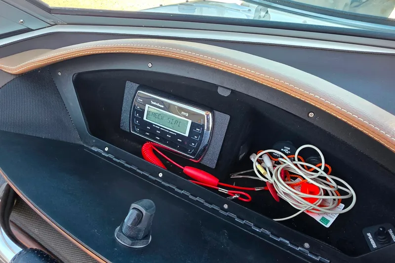 Slide: The Image of Dashboard of a 2013 Cobalt A25 boat with stereo and cables. - 21