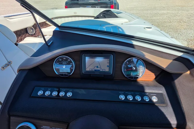 Slide: The Image of Dashboard of a 2013 Cobalt A25 boat with gauges and navigation screen. - 24