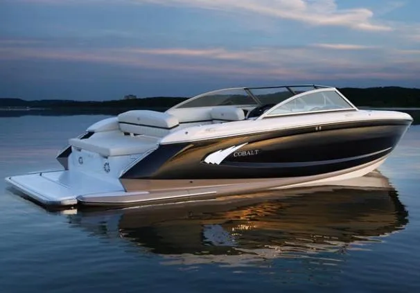 Slide: The Image of 2013 Cobalt A25 boat on trailer, black and red design, covered, parked outdoors. - 3