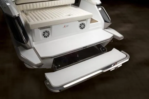 Slide: The Image of 2013 Cobalt A25 boat interior with white leather seating and wood accents. - 6