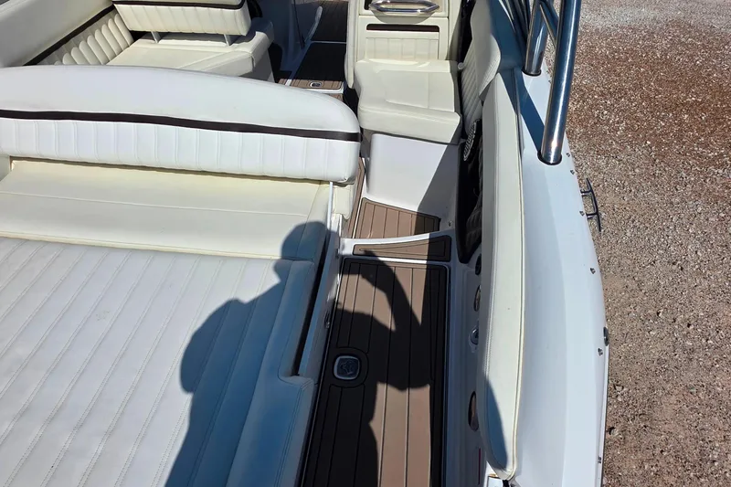 Slide: The Image of 2013 Cobalt A25 boat interior with white seating and brown flooring. - 7