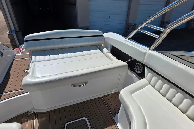 Slide: The Image of 2013 Cobalt A25 boat interior with white leather seating and wood flooring. - 9