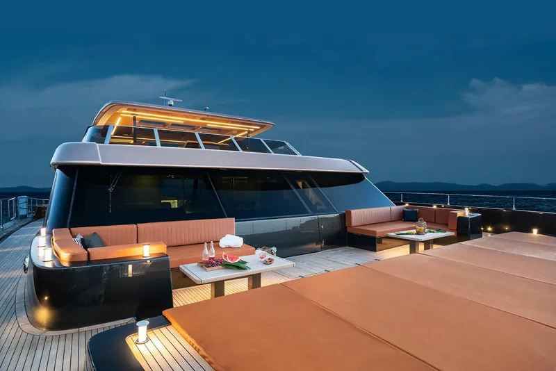 The Image of Luxurious 2026 Sunreef 100 Power yacht with elegant deck seating at sunset. - 1