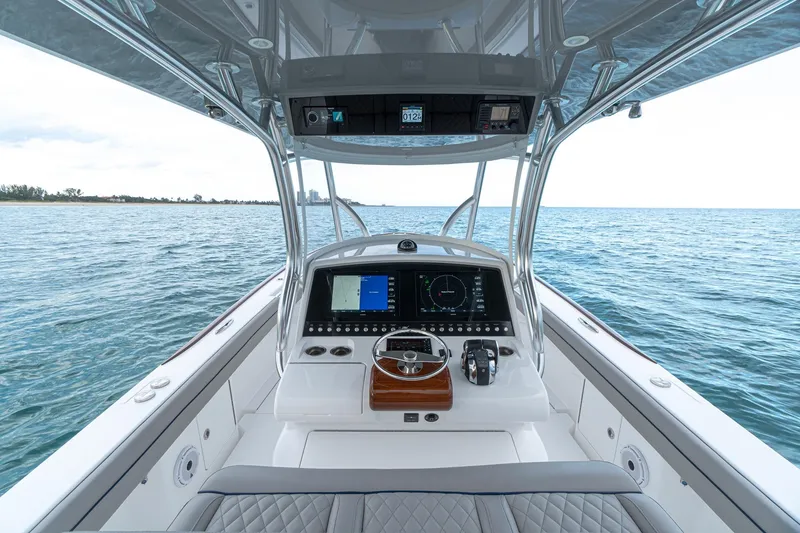 Slide: The Image of 2021 Valhalla V-33 boat dashboard with dual Garmin displays and navigation controls. - 2