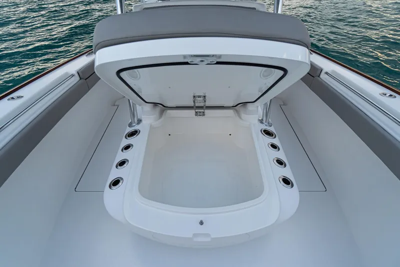 Slide: The Image of 2021 Valhalla Boatworks V-33 interior with gray cushioned seating and steering wheel. - 4