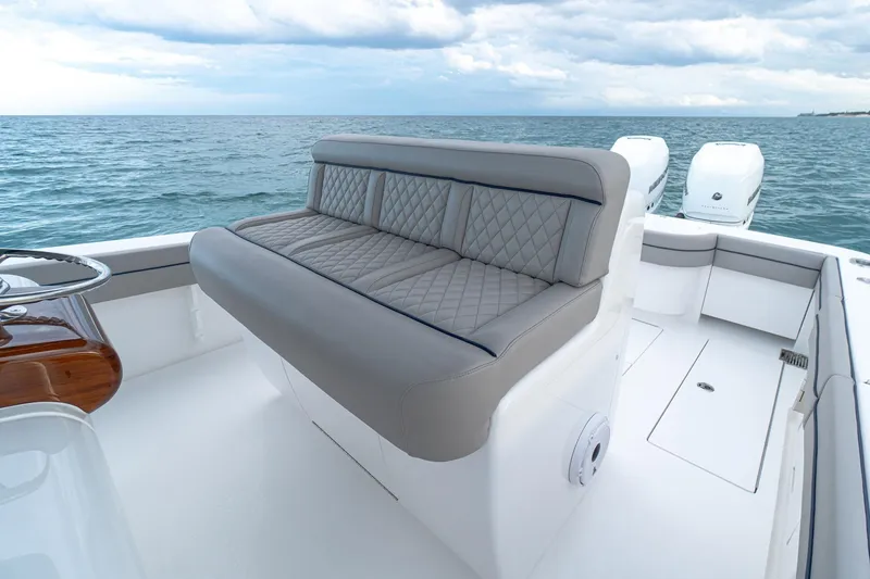 Slide: The Image of 2021 Valhalla Boatworks V-33 interior with sleek white surfaces and storage compartments. - 6