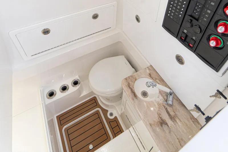 Slide: The Image of 2021 Valhalla Boatworks V-33 interior bathroom with toilet, sink, and control panel. - 7