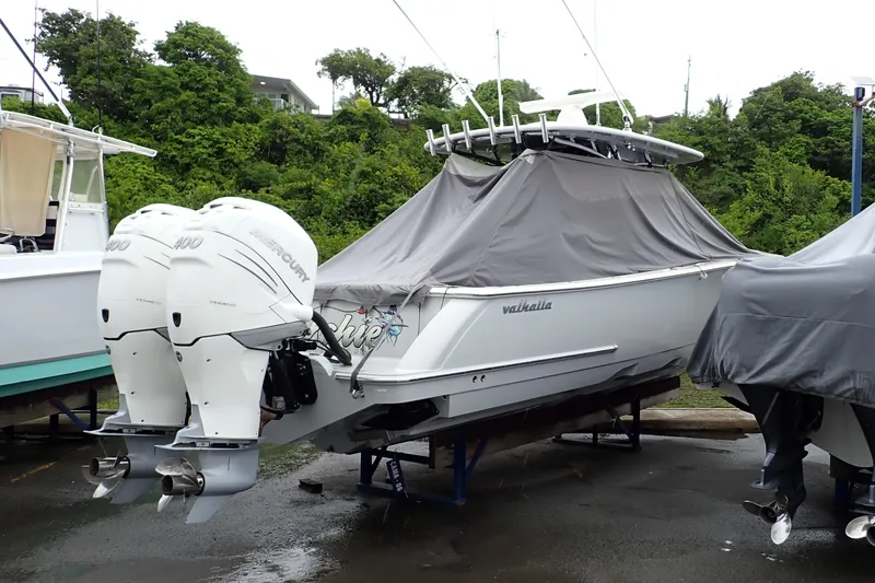 Slide: The Image of 2021 Valhalla Boatworks V-33 with twin Mercury engines, covered and docked outdoors. - 9