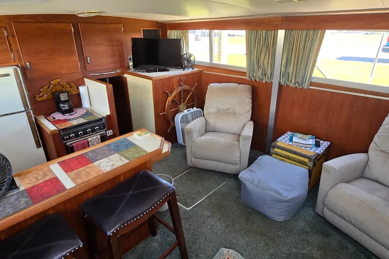 Slide: The Image of Interior of 1979 Chris-Craft 410 Motor Yacht with cozy seating and nautical decor. - 11