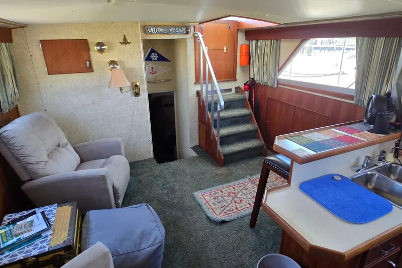 Slide: The Image of Interior of 1979 Chris-Craft 410 Motor Yacht with cozy seating and nautical decor. - 12
