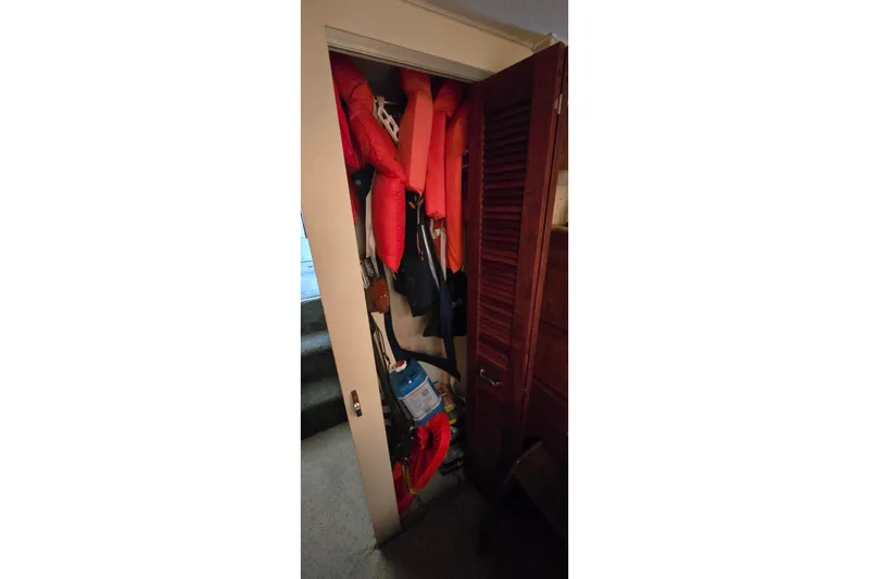 Slide: The Image of Storage closet with life jackets and supplies on a 1979 Chris-Craft 410 Motor Yacht. - 18