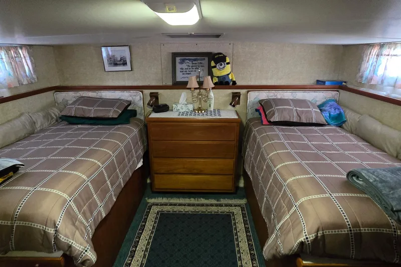 Slide: The Image of 1979 Chris-Craft 410 Motor Yacht cabin with twin beds and cozy decor. - 24