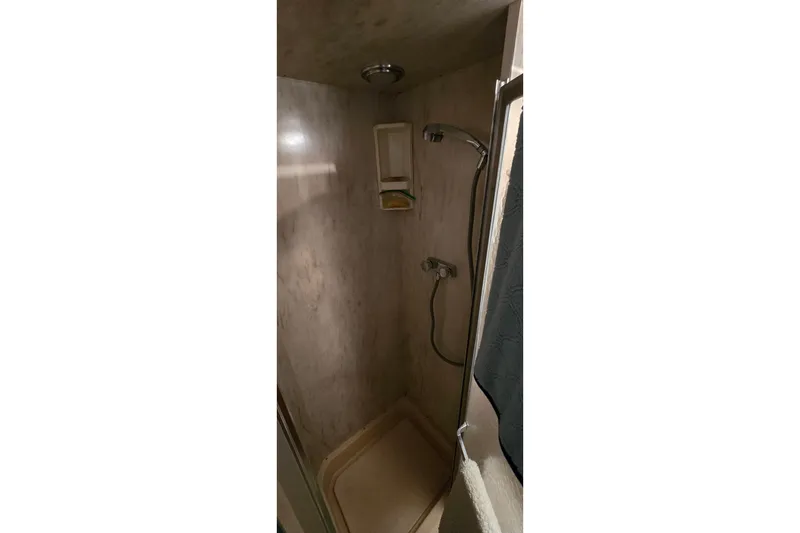 Slide: The Image of Shower area in 1979 Chris-Craft 410 Motor Yacht, featuring a compact design. - 27