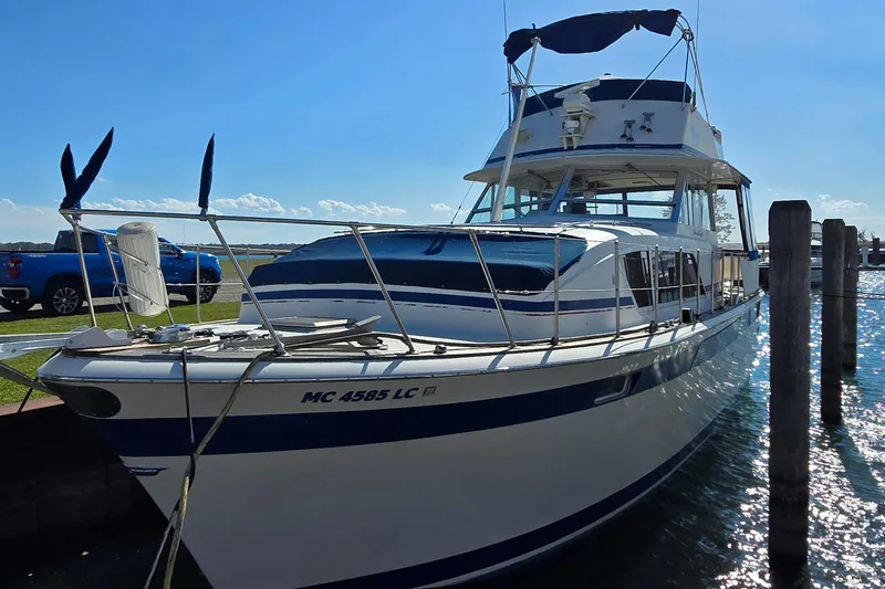Slide: The Image of 1979 Chris-Craft 410 Motor Yacht docked in sunny marina setting. - 3