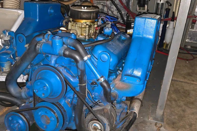 Slide: The Image of Engine of a 1979 Chris-Craft 410 Motor Yacht, painted blue, with visible hoses and components. - 30