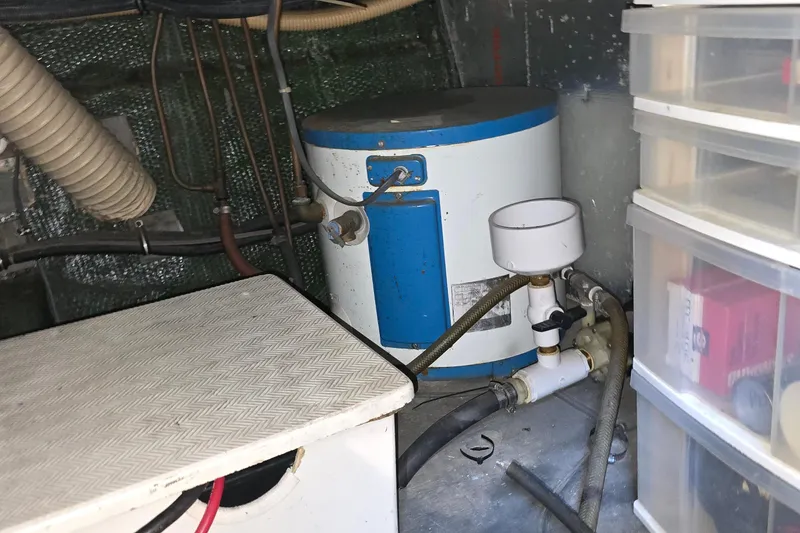 Slide: The Image of Engine room of 1979 Chris-Craft 410 Motor Yacht with water heater and storage. - 32