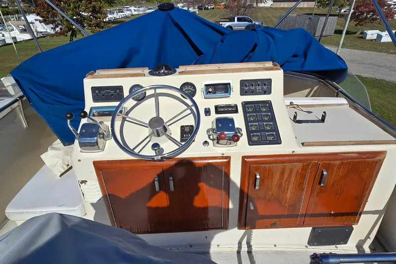 Slide: The Image of 1979 Chris-Craft 410 Motor Yacht helm with steering wheel and control panel. - 8