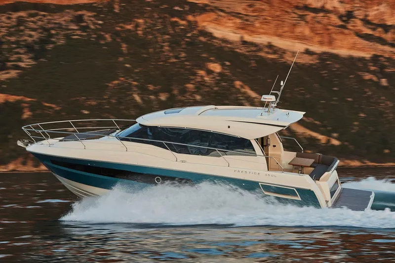 Slide: The Image of 2025 Prestige 460S yacht cruising on open water with passengers enjoying the view. - 2